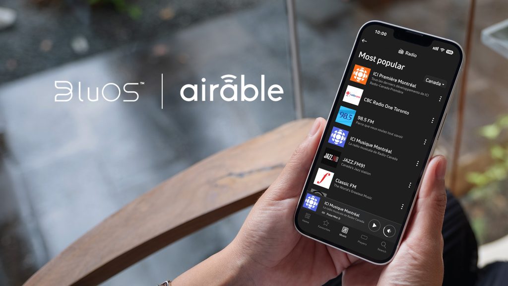 BluOS and airable logos with bluos app on a phone